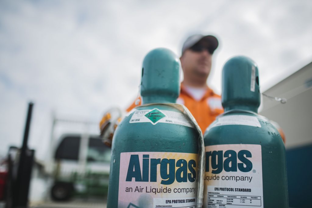 Airgas cannisters with an Airgas worker in the background