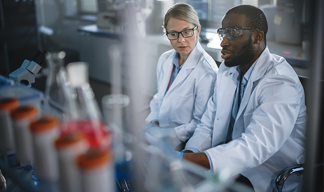 Scientists observing and discussing data in a clean laboratory