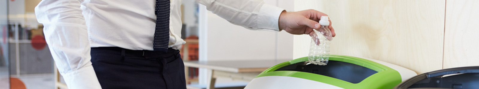 Professional business person using recycling bin to support sustainability