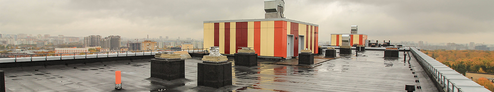 A commercial rooftop in a storm with grey clouds in the distance