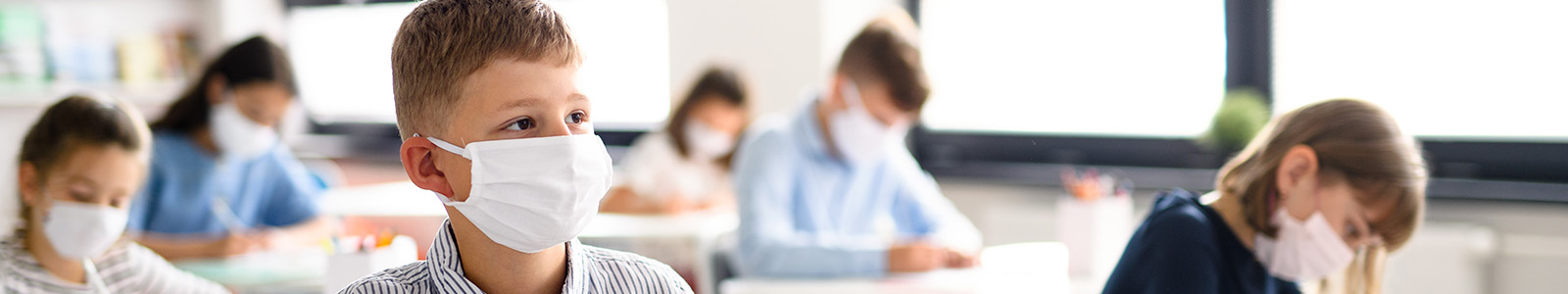 Elementary school children wearing N95 masks in classroom