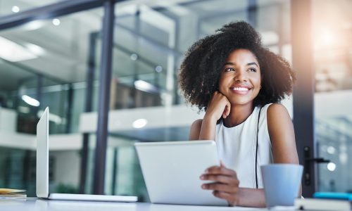 Smiling professional woman at work looking off to the side