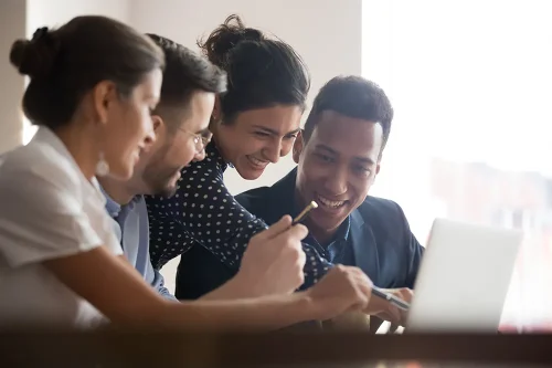 Group of smiling diverse procurement professionals working together