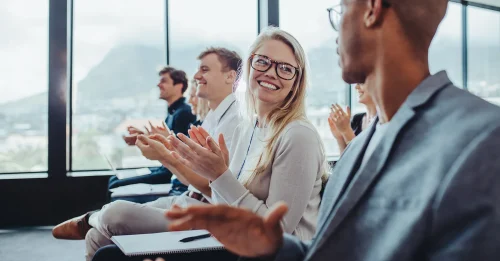 Smiling professionals clapping together